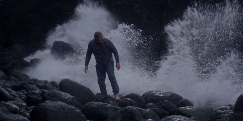 Ólafur Darri Ólafsson as Gulli, the lone survivor of the shipwrecked Brecki, shoeless and freezing after washing up on a rocky shore. Photo courtesy Balthasar Kormákur