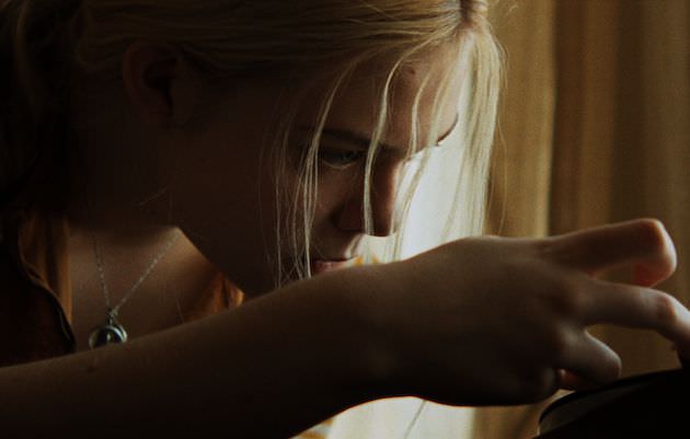 Elle Fanning as Amy-Jo Albany, playing a beloved jazz record. Courtesy Sundance Film Festival.