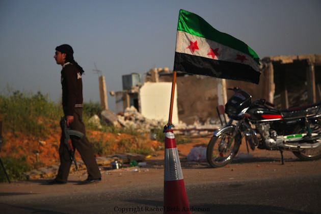 An FSA guard stands outside a checkpoint in the countryside of Idlib, Syria.