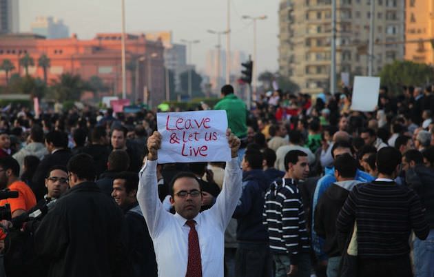 One Egyptian man holds a sign for the outside world to see exactly what the protestors in Egypt felt they wanted at that time…many thought have changed now with hindsight. Photo by Rachel Beth Anderson.