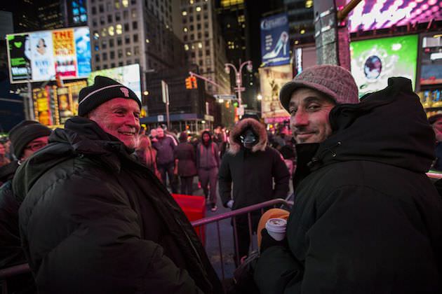 Producer Avi Arad, left, and Producer Matt Tolmach in Times Square. Jamie Foxx, as Electro, can be seen standing behind them. Courtesy Sony Pictures.