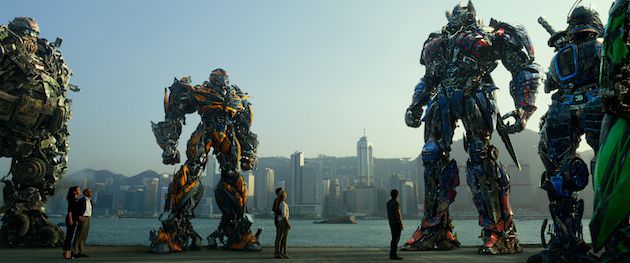 Left to right: Hound, Bingbing Li plays Su Yueming, Stanley Tucci plays Joshua Joyce, Bumblebee, Jack Reynor plays Shane Dyson, Nicola Peltz plays Tessa Yeager, Mark Wahlberg plays Cade Yeager, Optimus Prime, Drift, and Crosshairs in TRANSFORMERS: AGE OF EXTINCTION, from Paramount Pictures.