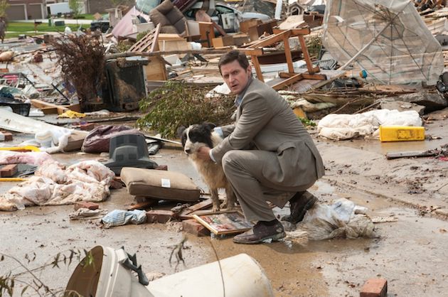 Richard Armitage stars as Gary, a father of two standing amidst the rubble of what was once his neighborhood. Courtesy Warner Bros. 