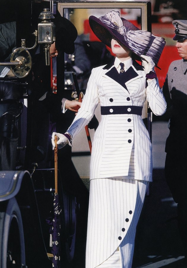 Rose DeWitt Bukater (Kate Winslet) in a costume by Deborah L. Scott. "Her white suit is finely tailored, constructed of white twill fabric with dark violet pinstripes, lapels, cuffs, belt and buttons. Narrow hobble skirt constricts Rose's movement, displaying fashionable pre-World War I silhouette. Ensemble is completed with large picture hat made of Milan straw with a double bow." - Courtesy 'Hollywood Costume' exhibit.