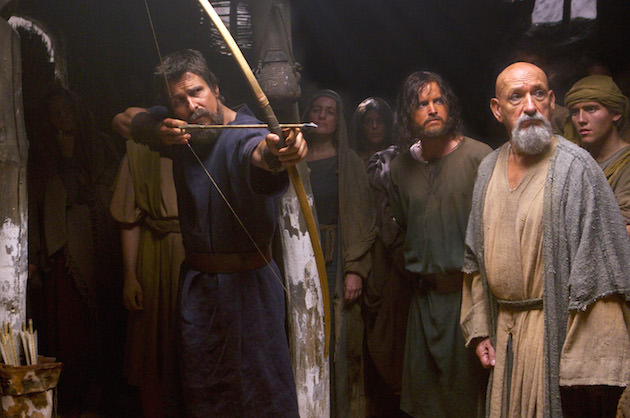 Moses (Christian Bale) displays his prowess with a bow and arrow, as Joshua (Aaron Paul, center) and Nun the scholar (Ben Kingsley) watch. Courtesy 20th Century Fox. 