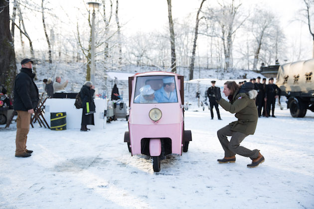 Tony Revolori and Ralph Fiennes in the vehicle with director Wes Anderson outside, on the set of The Grand Budapest Hotel. Courtesy Fox Searchlight.