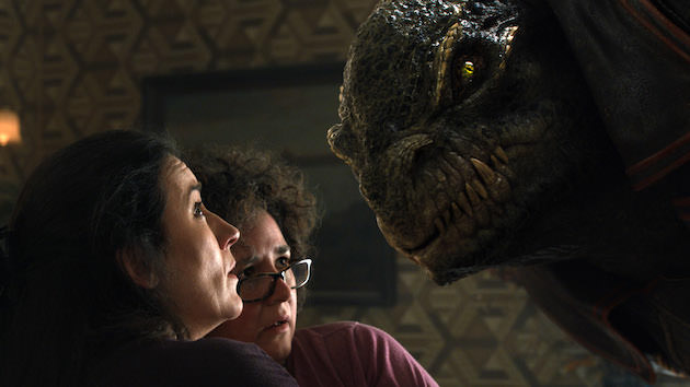 L-r:  Aleksa (Maria Doyle Kennedy), and Aunt Nino (Frog Stone) get a visit from Greeghan (Ariyon Bakare). Courtesy Warner Bros. Pictures. 