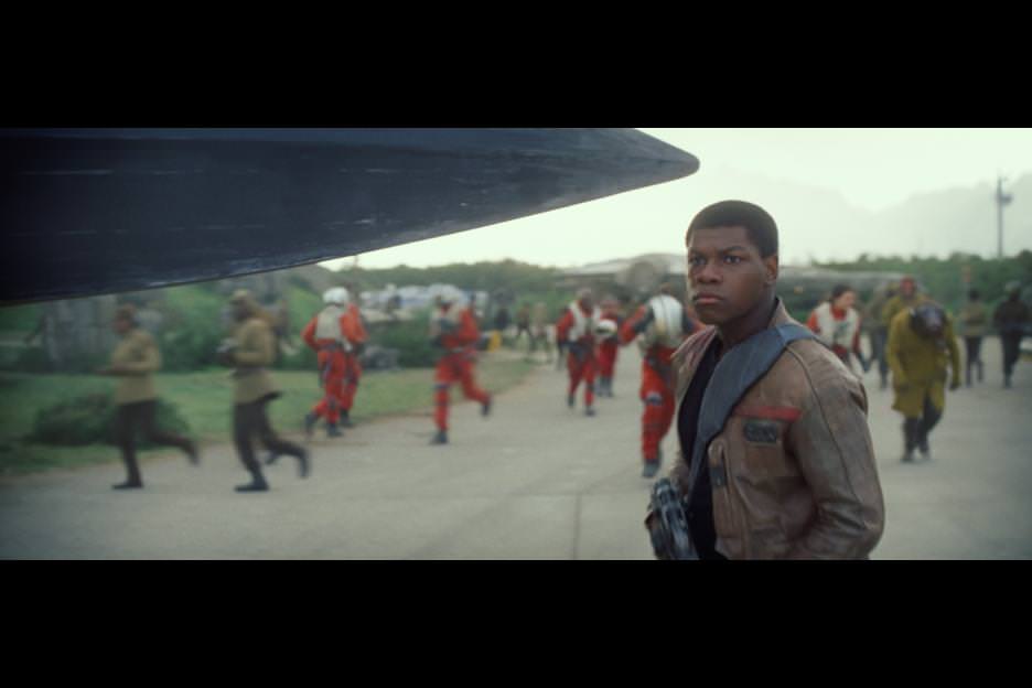 Finn (John Boyega) the moment he bumps into Poe Dameron (Oscar Isaac) on the tarmac. Courtesy Walt Disney Pictures/Lucasfilm