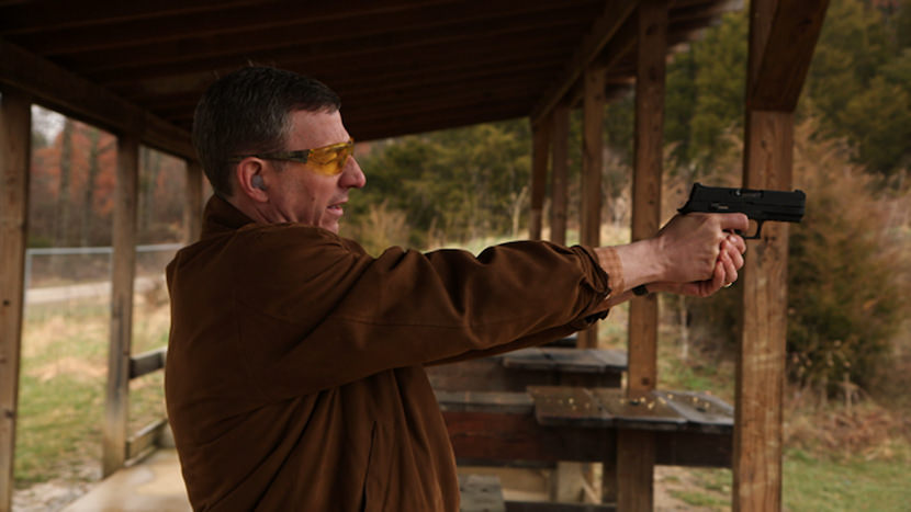 Rev. Bob Scheck at the firing range. Photo by Jeff Hutchens.