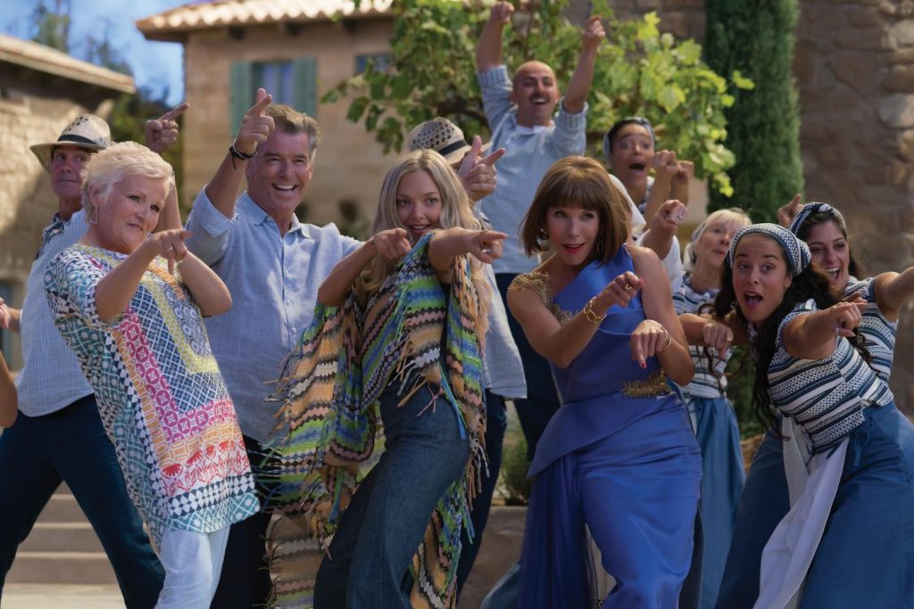 (L to R, center) Rosie (JULIE WALTERS), Sam (PIERCE BROSNAN), Sophie (AMANDA SEYFRIED) and Tanya (CHRISTINE BARANSKI) in "Mamma Mia! Here We Go Again." Ten years after "Mamma Mia! The Movie," you are invited to return to the magical Greek island of Kalokairi in an all-new original musical based on the songs of ABBA. Photo Credit: Jonathan Prime
