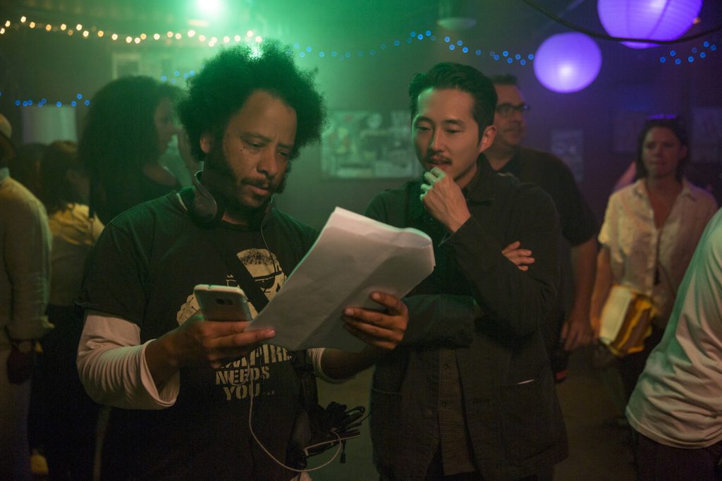 (l to r.) Director Boots Riley and Steven Yeun on the set of SORRY TO BOTHER YOU, an Annapurna Pictures release.