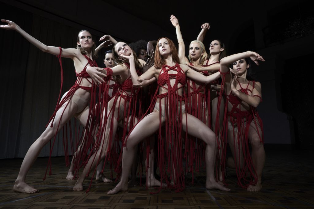 Mia Goth as Sara and Dakota Johnson as Susie star in Suspiria. Photo Credit: Alessio Bolzoni; Courtesy of Amazon Studios