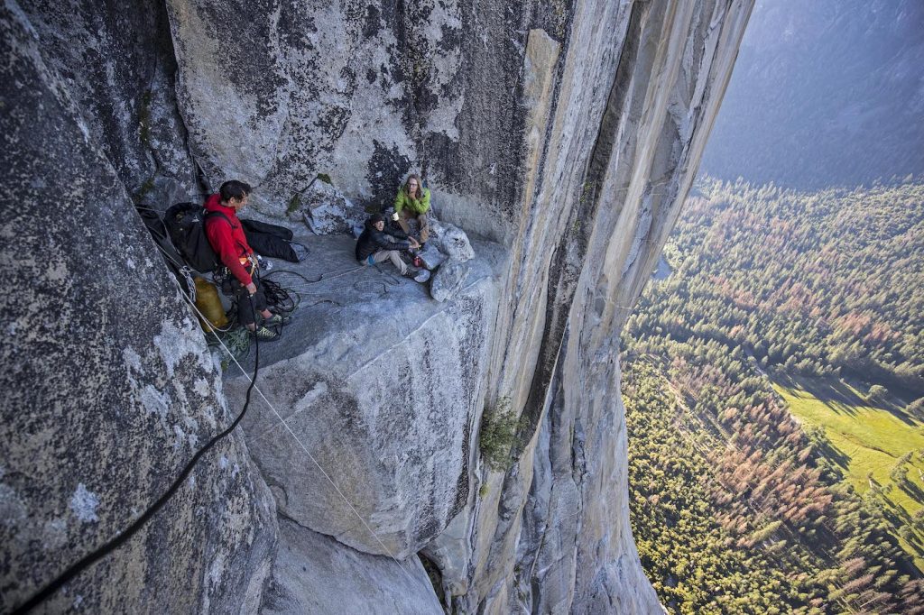 Alex Honnold meeting a couple climbers as he rappels El Capitan's Freerider route to practice on the climb before his free solo attempt. National Geographic/Jimmy Chin.