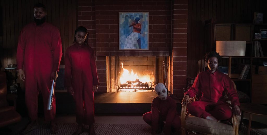 The Wilson family doppelgängers (from left) Abraham (Winston Duke), Umbrae (Shahadi Wright Joseph), Pluto (Evan Alex) and Red (Lupita Nyong’o) in "Us," written, produced and directed by Jordan Peele. Courtesy Universal Pictuers