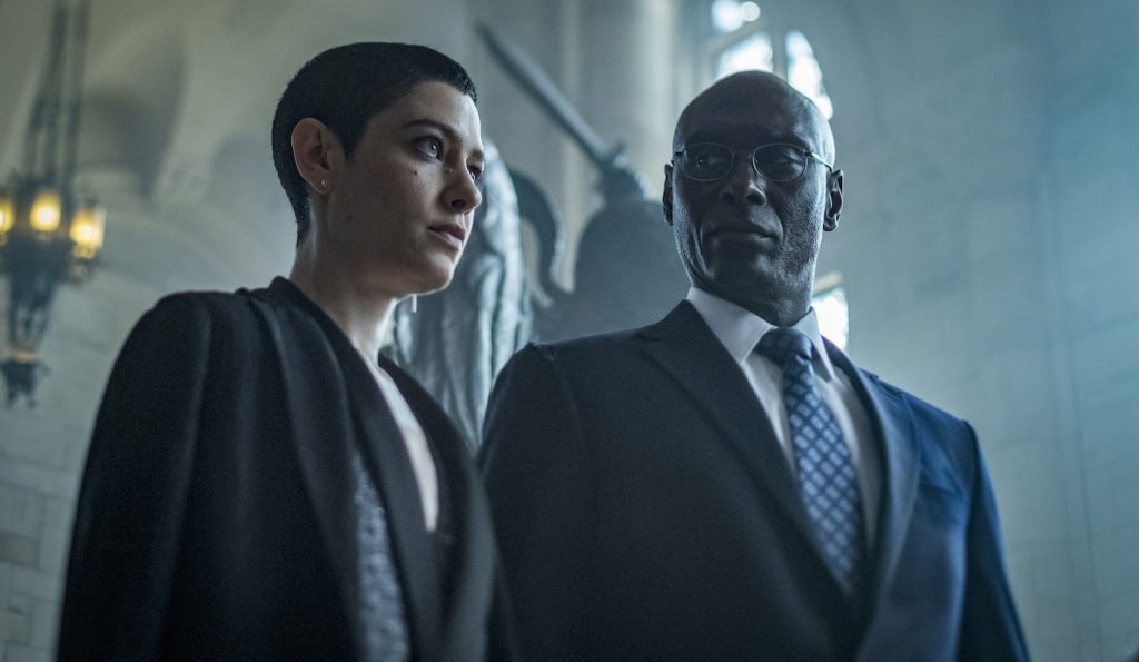 The Adjudicator (Asia Kate Dillon) and Charon (Lance Reddick). Photo by Niko Tavernise. Courtesy Lionsgate.