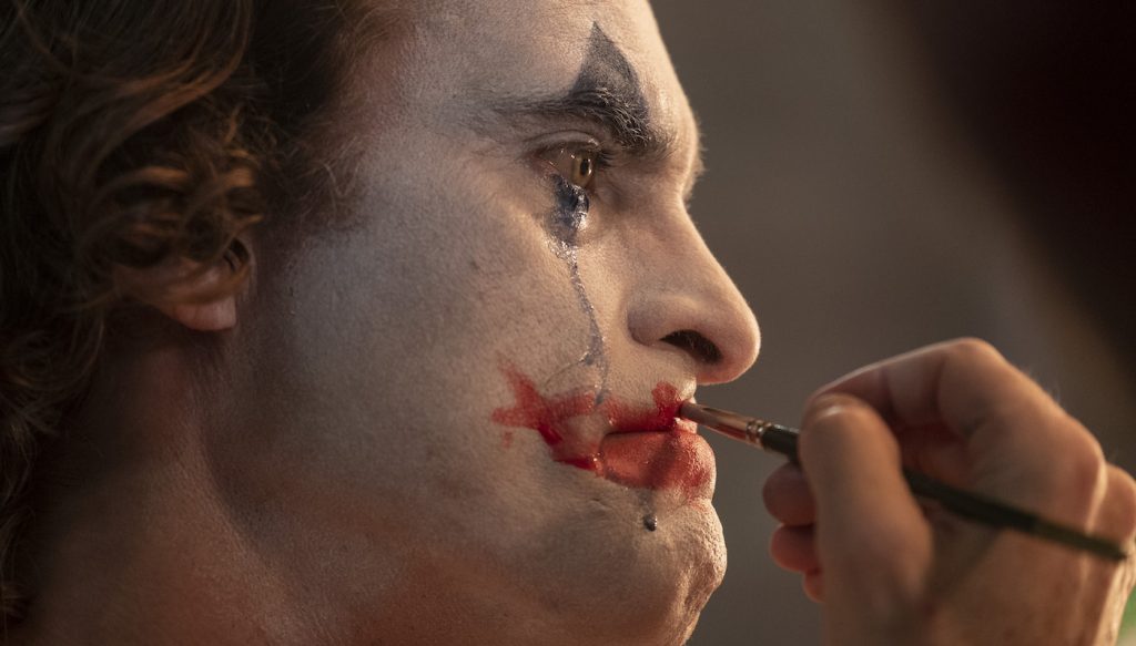 Caption: (Center) JOAQUIN PHOENIX as Arthur Fleck in Warner Bros. Pictures, Village Roadshow Pictures and BRON Creative’s tragedy “JOKER,” a Warner Bros. Pictures release. Photo Credit: Niko Tavernise. Copyright: © 2019 Warner Bros. Entertainment Inc.