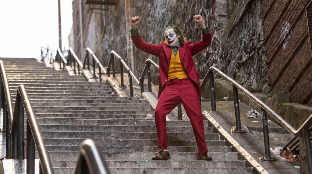 Caption: (Center) JOAQUIN PHOENIX as Arthur Fleck in Warner Bros. Pictures, Village Roadshow Pictures and BRON Creative’s tragedy “JOKER,” a Warner Bros. Pictures release. Photo Credit: Niko Tavernise. Copyright: © 2019 Warner Bros. Entertainment Inc.