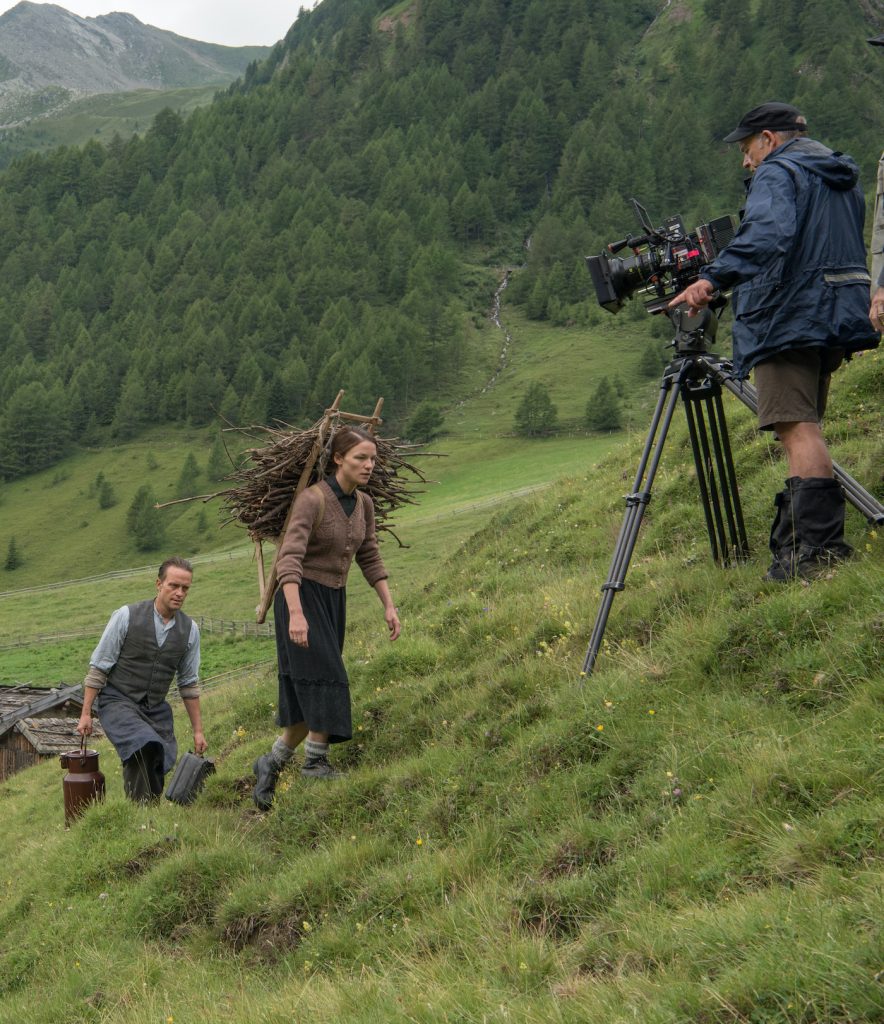 (From L-R): August Diehl, Valerie Pachner and Director of Photography Joerg Widmer on the set of A HIDDEN LIFE. Photo by Reiner Bajo. © 2019 Twentieth Century Fox Film Corporation All Rights Reserved