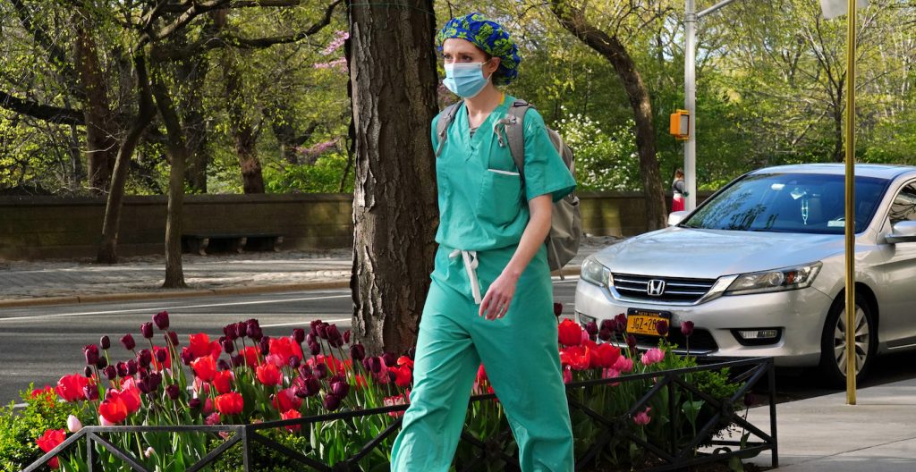 NEW YORK, NEW YORK - APRIL 28: A medical worker walks while wearing a protective mask during the coronavirus pandemic on April 28, 2020 in New York City. COVID-19 has spread to most countries around the world, claiming over 217,000 lives with over 3.1 million infections reported. (Photo by Cindy Ord/Getty Images)