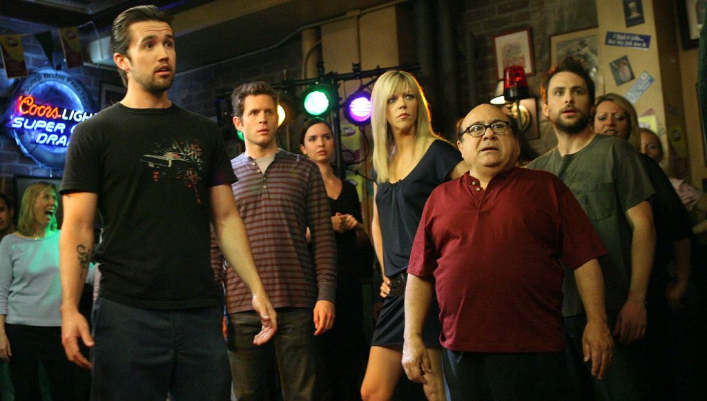 LOS ANGELES, CA - MAY 23:  (L-R) Actors Rob McElhenney, Glenn Howerton, Kaitlin Olson, Danny DeVito and Charlie Day act during a dance scene on the set of 