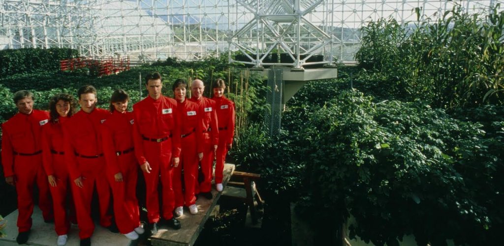 The 'Biospherians' pose for the camera during the final construction phase of the Biosphere 2 project in 1990. Left to right are: Mark Nelson, Linda Leigh, Taber MacCallum, Abigail Alling, Mark Van Thillo, Sally Silverstone, Roy Walford and Jayne Poynter. The 3.1 acre air- and water-tight building became their home for two years. Biosphere 2 was designed to allow study of human survival in a sealed ecosystem. The costs of this controversial, $150 million project were met from private funds. The Biosphere 2 project building is at Oracle, Arizona.