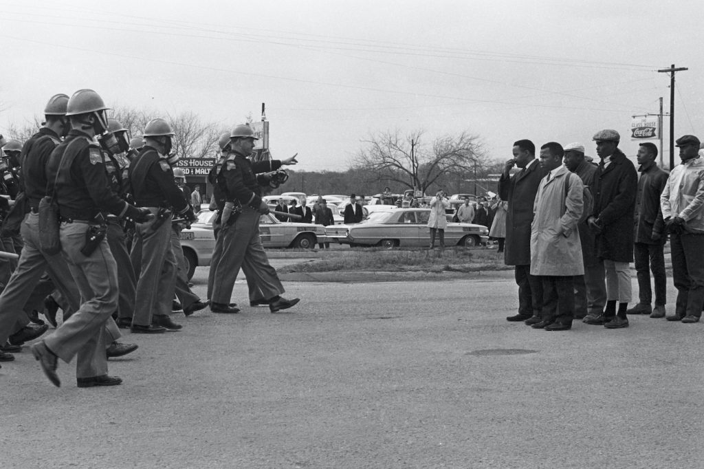 Protestors and police officers on Bloody Sunday, in JOHN LEWIS: GOOD TROUBLE, a Magnolia Pictures release. © Spider Martin. Photo courtesy of Magnolia Pictures.