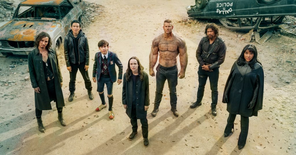 THE UMBRELLA ACADEMY (L to R) ROBERT SHEEHAN as KLAUS HARGREEVES, JUSTIN H. MIN as BEN HARGREEVES, AIDAN GALLAGHER as NUMBER FIVE, ELLEN PAGE as VANYA HARGREEVES, TOM HOPPER as LUTHER HARGREEVES, DAVID CASTAÑEDA as DIEGO HARGREEVES and EMMY RAVER-LAMPMAN as ALLISON HARGREEVES in episode 201 of THE UMBRELLA ACADEMY Cr. CHRISTOS KALOHORIDIS/NETFLIX © 2020