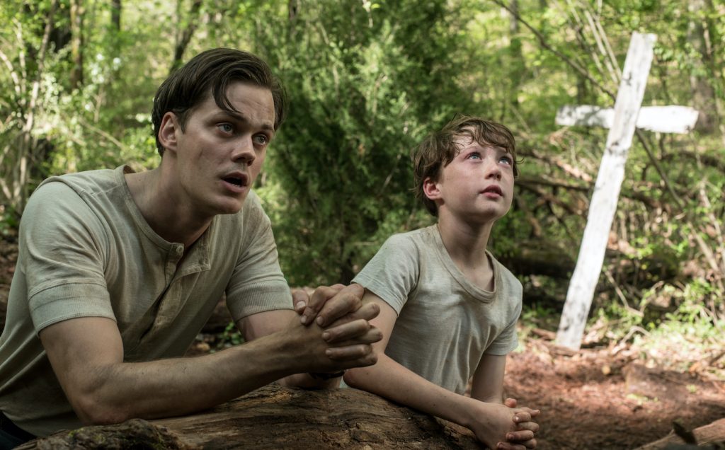 The Devil All The Time (L-R) Bill Skarsgård as Willard Russell, Michael Banks Repeta as Arvin Russell (9 Years Old). Photo Cr. Glen Wilson/Netflix © 2020