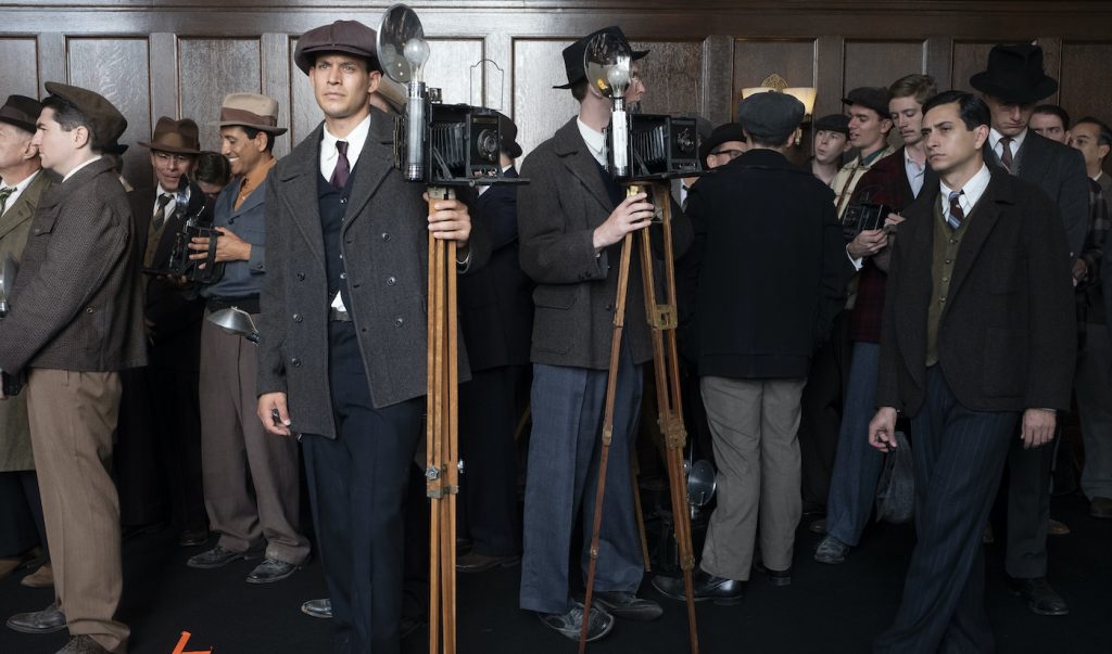 Background actors portraying news photographers await their turn during a setup change in the Courtroom set on Paramount’s Stage 27. Photo by MERRICK MORTON/HBO.