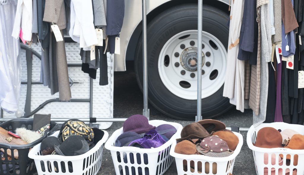 An assortment of a hats of different colors to be provided to background actors by Set Costumers at a location shoot. Photo by Merrick Morton/HBO. 