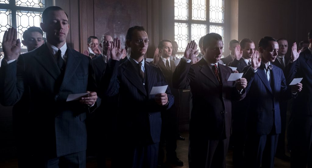 Twelve good men and true:  a dozen background cast, who work in repeat performance throughout the season, take the oath as the trial’s jury members. Courtesy Merrick Morton/HBO