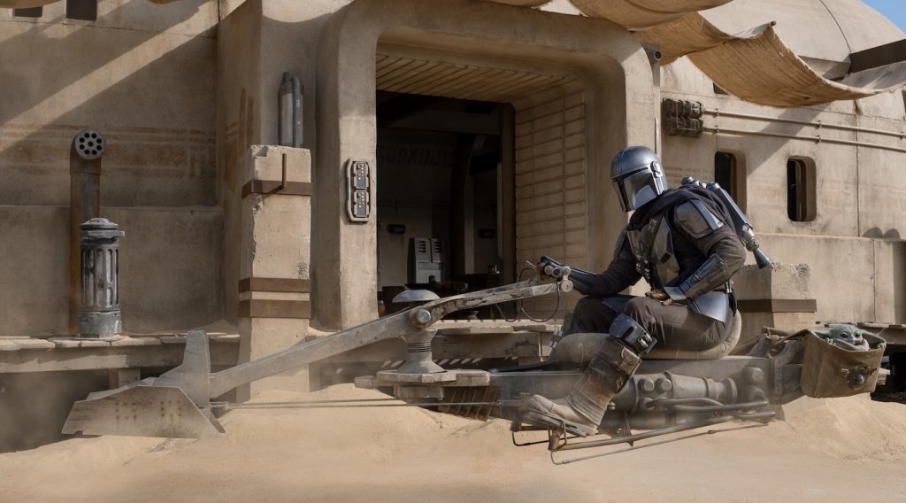 The Mandalorian (Pedro Pascal) and the Child in The Mandalorian, season two. Courtesy Lucasfilm.