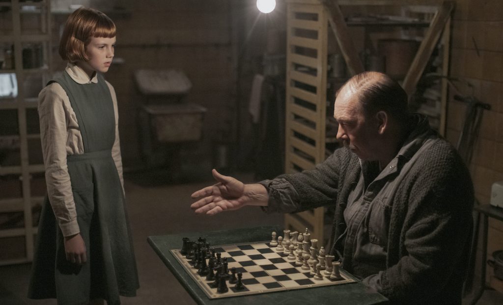 THE QUEEN’S GAMBIT (L to R) ISLA JOHNSTON as BETH (ORPHANAGE) and BILL CAMP as MR. SHAIBEL in episode 101 of THE QUEEN’S GAMBIT Cr. PHIL BRAY/NETFLIX © 2020