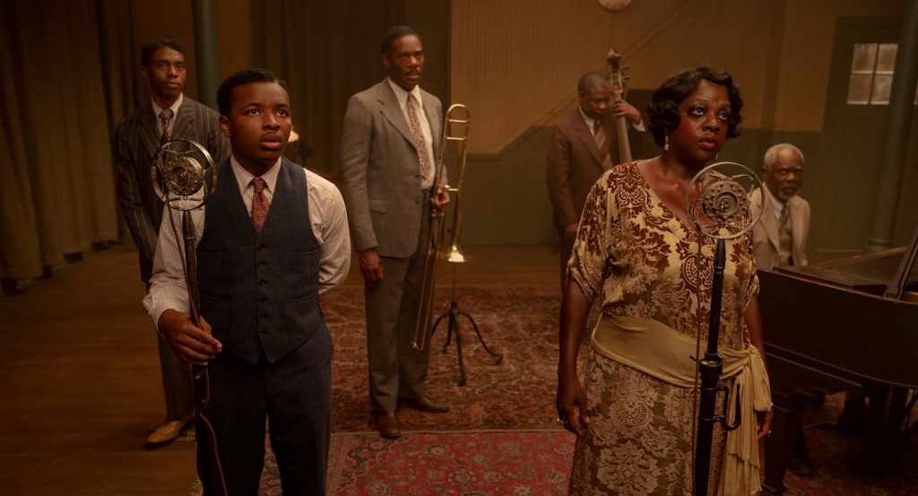 Ma Rainey's Black Bottom (2020): (L to R) Chadwick Boseman ("Levee"), Dusan Brown ("Sylvester"), Colman Domingo ("Cutler"), Michael Potts ("Slow Drag"), Viola Davis ("Ma Rainey"), Glynn Turman ("Toldeo") Cr. David Lee / Netflix