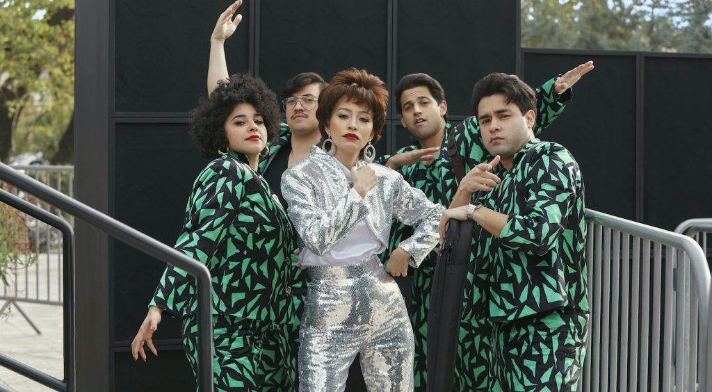 SELENA THE SERIES (L to R) NOEMI GONZALEZ as SUZETTE QUINTANILLA and HUNTER REESE PENA as RICKY VELA and CHRISTIAN SERRATOS as SELENA QUINTANILLA and PAUL RODRIGUEZ JR. as ROGER GARCIA and GABRIEL CHAVARRIA as A.B QUINTANILLA in episode 103 of SELENA THE SERIES Cr. Sara Khalid/NETFLIX © 2020
