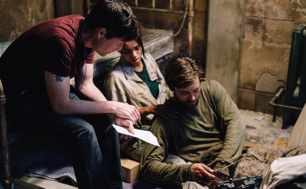 Director, Jonathan W. Stokes, Georgina Campbell as Khadija Young, and Luke Benward as Luke White behind the scenes of the thriller WILDCAT, a Saban Films release. Photo courtesy of Saban Films.