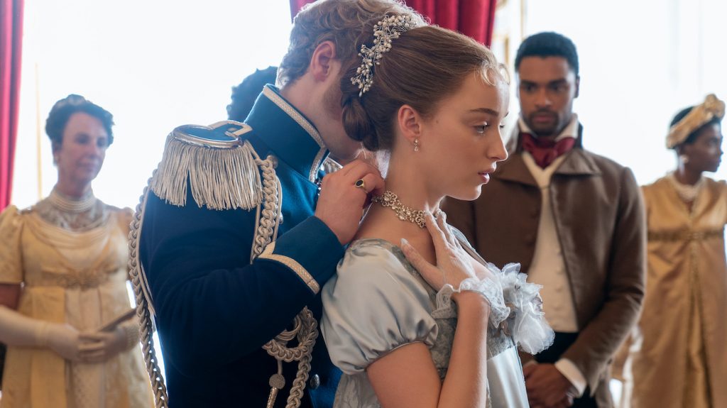 BRIDGERTON (L to R) FREDDIE STROMA as PRINCE FRIEDERICH, PHOEBE DYNEVOR as DAPHNE BRIDGERTON and REGÉ-JEAN PAGE as SIMON BASSET in episode 104 of BRIDGERTON Cr. LIAM DANIEL/NETFLIX © 2020