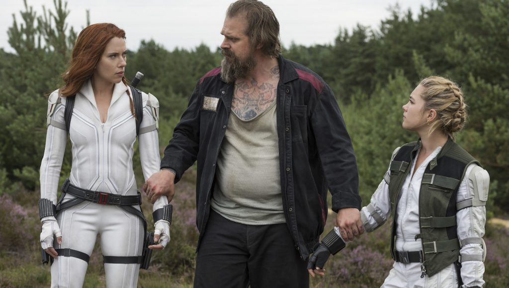 L-r: Black Widow/Natasha Romanoff (Scarlett Johansson), Alexei (David Harbour), and Yelena (Florence Pugh) in Marvel Studios' BLACK WIDOW. Photo by Jay Maidment. ©Marvel Studios 2020.