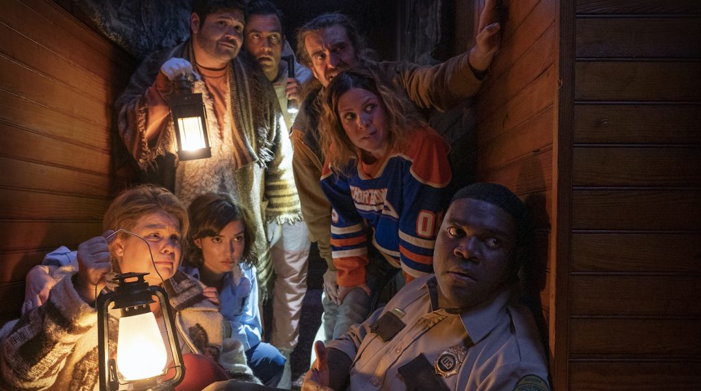 (Clockwise from lower right) Sam Richardson, Milana Vayntrub, Catherine Curtin, Harvey Guillen, Cheyenne Jackson, George Basil and Sarah Burns in WEREWOLVES WITHIN. Courtesy IFC Films.