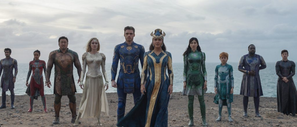 (L-R): Kingo (Kumail Nanjiani), Makkari (Lauren Ridloff), Gilgamesh (Don Lee), Thena (Angelina Jolie), Ikaris (Richard Madden), Ajak (Salma Hayek), Sersi (Gemma Chan), Sprite (Lia McHugh), Phastos (Brian Tyree Henry) and Druig (Barry Keoghan) in Marvel Studios' ETERNALS. Photo courtesy of Marvel Studios. ©Marvel Studios 2021. All Rights Reserved.