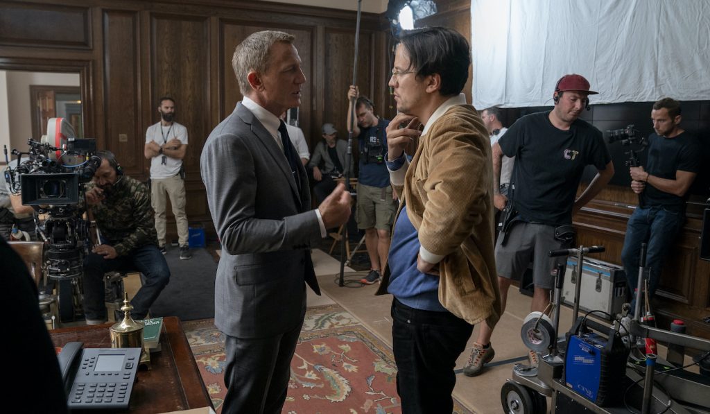 Daniel Craig (James Bond) and director Cary Joji Fukunaga on the set of NO TIME TO DIE, an EON Productions and Metro-Goldwyn-Mayer Studios film Credit: Nicola Dove © 2021 DANJAQ, LLC AND MGM. ALL RIGHTS RESERVED.