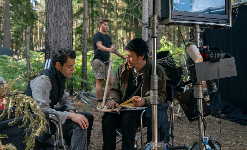 Rami Malek (Safin) and director Cary Joji Fukunaga on the set of NO TIME TO DIE, an EON Productions and Metro-Goldwyn-Mayer Studios film Credit: Nicola Dove © 2021 DANJAQ, LLC AND MGM. ALL RIGHTS RESERVED.