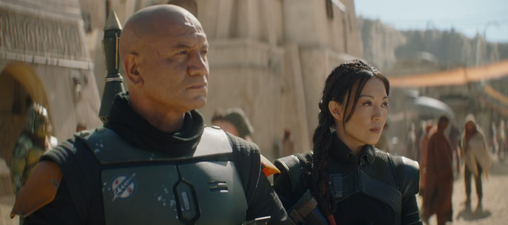 (L-R): Temura Morrison is Boba Fett and Ming-Na Wen is Fennec Shand in Lucasfilm's THE BOOK OF BOBA FETT, exclusively on Disney+. © 2021 Lucasfilm Ltd. & ™. All Rights Reserved.