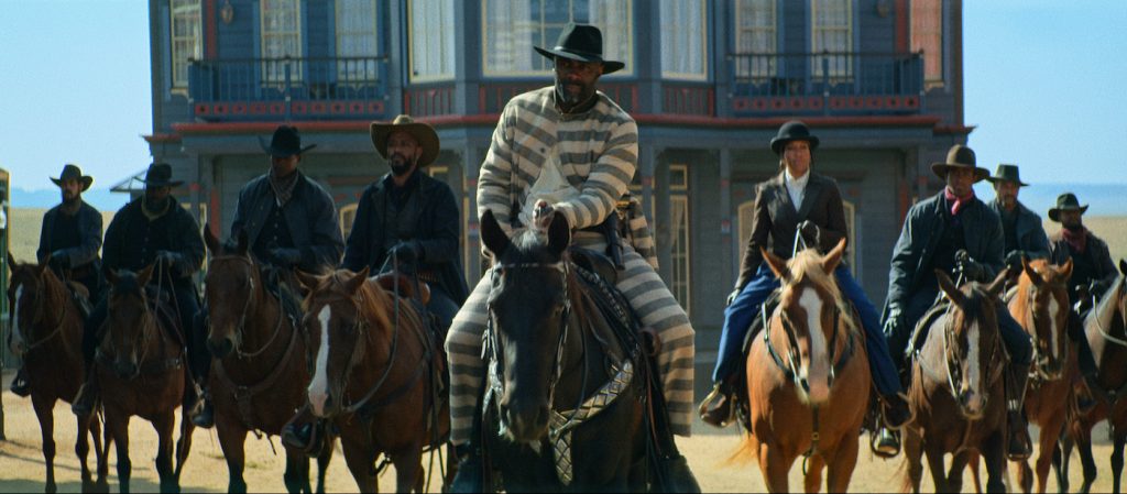 THE HARDER THEY FALL (L to R) (4th from Left): DELROY LINDO as BASS REEVES, IDRIS ELBA as RUFUS BUCK, and REGINA KING as TRUDY SMITH in THE HARDER THEY FALL Cr. COURTESY OF NETFLIX © 2021