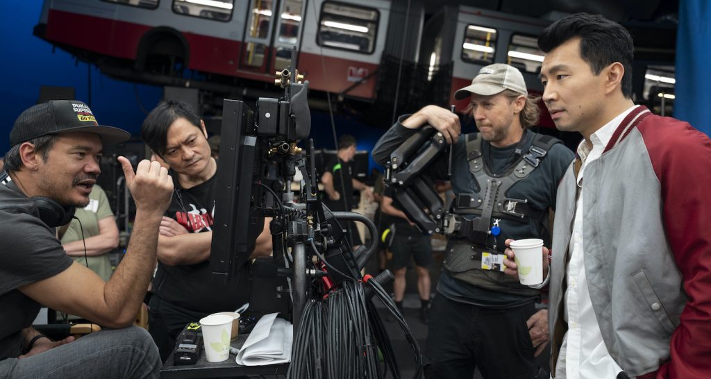 (L-R): Director Destin Daniel Cretton, fight instructor Andy Cheng, crew camera operator, and Simu Liu on the set of Marvel Studios' SHANG-CHI AND THE LEGEND OF THE TEN RINGS. Photo by Jasin Boland. ©Marvel Studios 2021. All Rights Reserved.