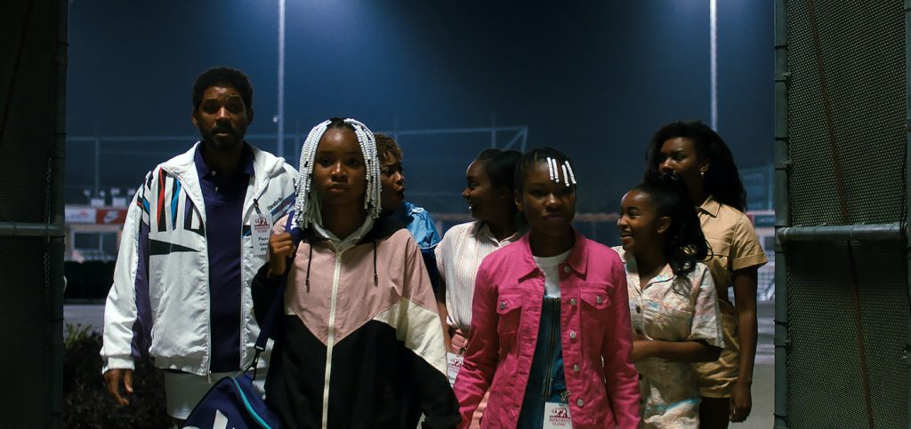 Caption: (L-r) WILL SMITH as Richard Williams, SANIYYA SIDNEY as Venus Williams, AUNJANUE ELLIS as Oracene “Brandy” Williams, DANIELE LAWSON as Isha Price, DEMI SINGLETON as Serena Williams, LAYLA CRAWFORD as Lyndrea Price and MIKAYLA BARTHOLOMEW as Tunde Price in Warner Bros. Pictures’ inspiring drama “KING RICHARD,” a Warner Bros. Pictures release. Photo Credit: Courtesy of Warner Bros. Pictures