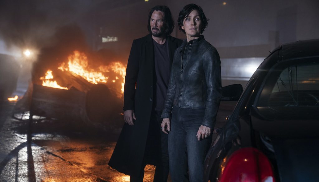 Caption: (L-r) KEANU REEVES as Neo/Thomas Anderson and CARRIE-ANNE MOSS as Trinity in Warner Bros. Pictures, Village Roadshow Pictures and Venus Castina Productions’ “THE MATRIX RESURRECTIONS,” a Warner Bros. Pictures release. Photo Credit: Murray Close