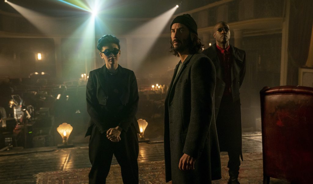 Caption: (L-r) JESSICA HENWICK as Bugs, KEANU REEVES as Neo/Thomas Anderson and YAHYA ABDUL-MATEEN II as Morpheus in Warner Bros. Pictures, Village Roadshow Pictures and Venus Castina Productions’ “THE MATRIX RESURRECTIONS,” a Warner Bros. Pictures release. Photo Credit: Murray Close