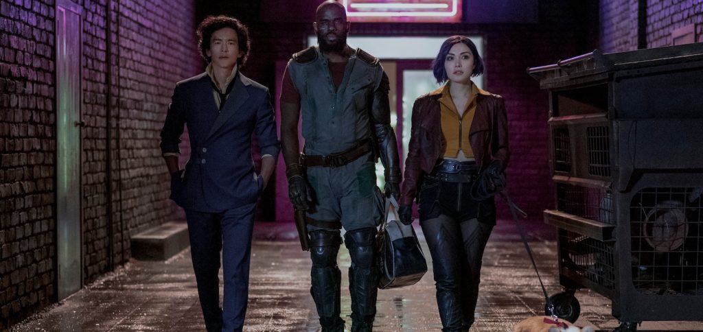 COWBOY BEBOP (L to R) JOHN CHO as SPIKE SPIEGEL, MUSTAFA SHAKIR as JET BLACK, DANIELLA PINEDA as FAYE VALENTINE and EIN in Cowboy Bebop Cr. GEOFFREY SHORT/NETFLIX © 2021