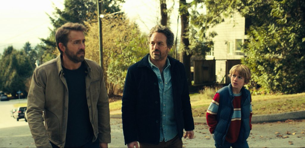 The Adam Project (L to R) Ryan Reynolds as Big Adam, Mark Ruffalo as Louis Reed and Walker Scobell as Young Adam. Cr. Netflix © 2022